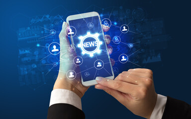 Female hand holding smartphone with NEWS abbreviation, modern technology concept