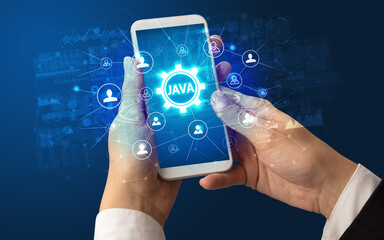 Female hand holding smartphone with JAVA abbreviation, modern technology concept