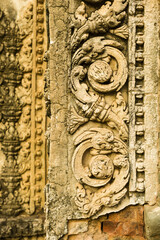 Naklejka premium detail of a carving on the Preah Ko temple in Roluos Group, Angkor, Siem Reap, Cambodia