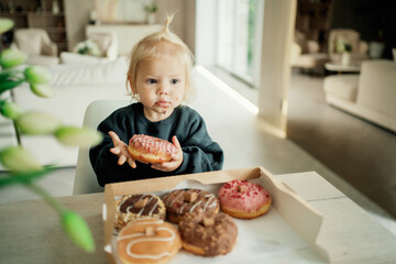 Courier fast delivery of food and sweets to your home. the most delicious dessert baking doughnuts from the bakery, with an appetite eats baby girl kids on their holiday.