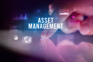 Fototapeta premium Finger touching tablet with charts and ASSET MANAGEMENT inscription, business concept