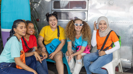 Obraz premium Young working women from different ethnic groups or races enjoy camping on a holiday. Friendship across cultures during vacation