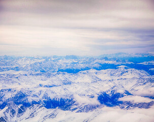 Fototapeta premium Aerial view of the Italian Alps at the end of summer with snow white peaks