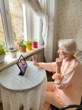 COVID-19 Stay Connected. Happy Senior Woman At Home Video Calling Family On Laptop Or Online Chatting With Long Distance Friends.