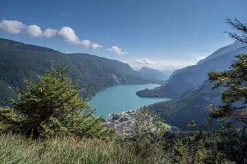 Naklejka na ściany i meble Molveno Lake, located in Trentino, by Molveno village, surrounded by Brenta group in the west & Gazza & Pagenella mountains in the south & east, as seen from Pradel high plain, Dolomites, Italy