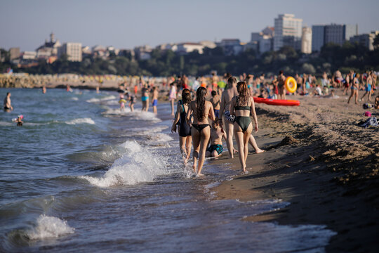 People enjoy the Black Sea beach during the Covid-19 outbreak during the dusk of a summer day.