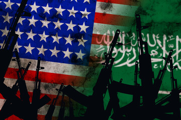 Several automatic rifles raised up on the background of the Saudi Arabia American flag