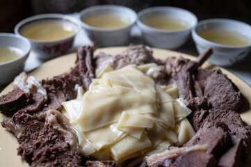 Beshbarmak (five fingers) - traditional kazakh and tatar dish made of bolied beef meat, bouillon, and dough (selective focus)