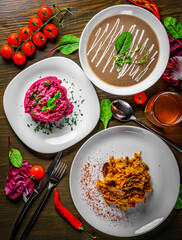 three-course set on a table. Tasty lunch set made of three meals, such as soup, salad and meat with rice