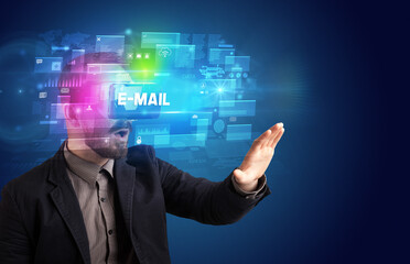 Businessman looking through Virtual Reality glasses with E-MAIL inscription, innovative security concept