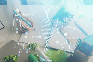 DNA theme hologram over woman's hands writing background. Concept of education. Double exposure