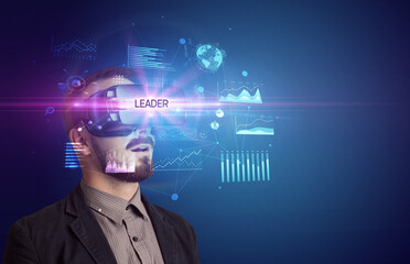Businessman looking through Virtual Reality glasses with LEADER inscription, new business concept