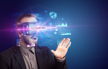Businessman looking through Virtual Reality glasses with ACCOUNTING inscription, new business concept