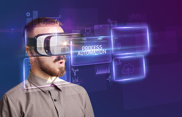 Businessman looking through Virtual Reality glasses with PROCESS AUTOMATION inscription, new technology concept