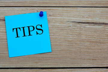 TIPS - acronym written on a blue sheet pinned to a wooden board