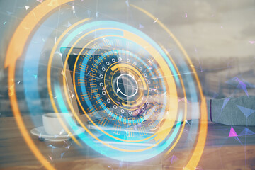 Technology theme hologram with man working on computer on background. High tech concept. Multi exposure.