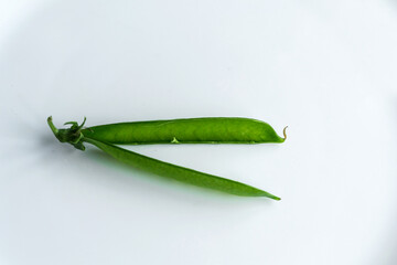 A single pea pod on an isolated white background.