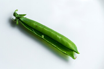 A single pea pod on an isolated white background.