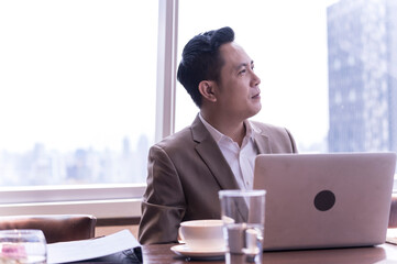 Portrait of happy businessman having meeting to success deal business at skyscraper office with cityscape business zone background