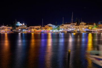 Fototapeta na wymiar Pithagorio marina in Samos,Greece at night with beautiful reflections 