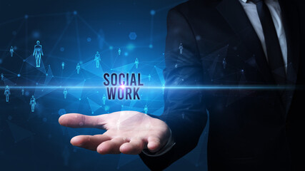 Elegant hand holding SOCIAL WORK inscription, social networking concept