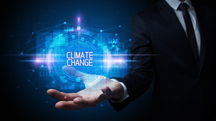 Man hand holding CLIMATE CHANGE inscription, technology concept
