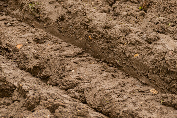 A mud track from a large construction machine, track in soil from an excavator, car, tank or other large machine