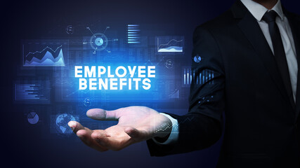 Hand of Businessman holding EMPLOYEE BENEFITS inscription, business success concept