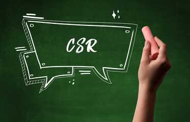 Hand drawing CSR abbreviation with white chalk on blackboard