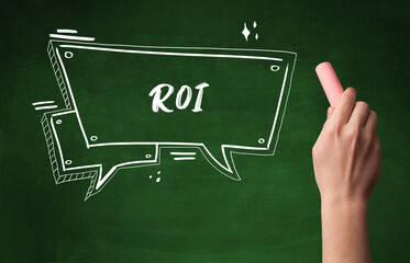 Hand drawing ROI abbreviation with white chalk on blackboard