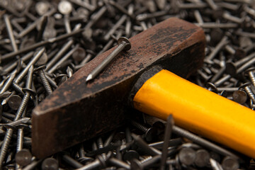 Metal construction nails and hammer.