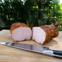 Smoked pork ham with paprika. Cold cuts on wooden board