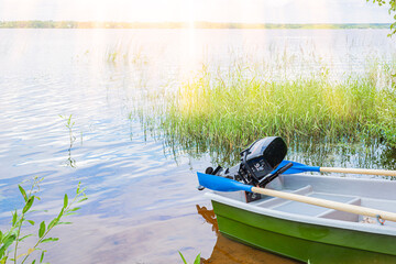 Motor boat with orange life jackets on the river bank