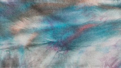textile background - detail of hand-colored abstract batik on cotton fabric