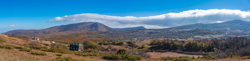 Panoramic view of the autumn mountain forests and the village