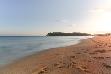 Long exposure shot of Poetto beach and distant view of Sella del Diavolo at sunset