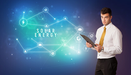 Businessman in front of cloud service icons with SOLAR ENERGY inscription, modern technology concept