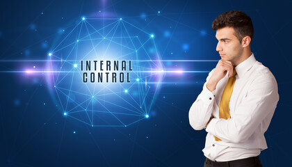 Businessman thinking about security solutions with INTERNAL CONTROL inscription