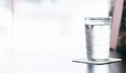 Closeup view glass of fresh water for drink on the table with bright background, copy space.