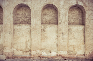 Close up of three arches from a heritage building facade. Details of grunge, old African architectural background.