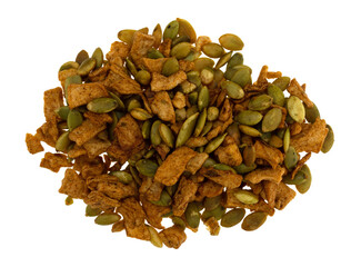 Portion of dried apple chunks with pumpkin seeds isolated on a white background.