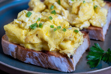 Scrambled eggs on toasted bread for healthy breakfast or brunch