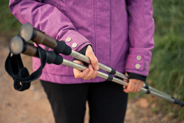 Nordic walking on sticks. a woman holding a Scandinavian stick close-up. healthy lifestyle
