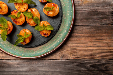 Summer dessert. Ripe grilled peaches with honey and mint leaves, banner, menu, recipe, place for text