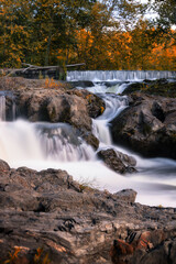 Fototapeta na wymiar Water flowing down a small picturesque waterfall. Madam Brett Park - Beacon, New York. 