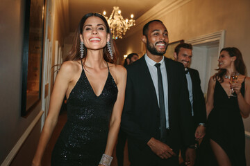 Group of people walking through nightclub corridor