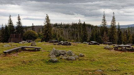 Empty benches and picnic tables in mountains glade area. Tourist rest place, hut in back. Rusinowa Polana, Tatra Mountains, Poland. © Fotema