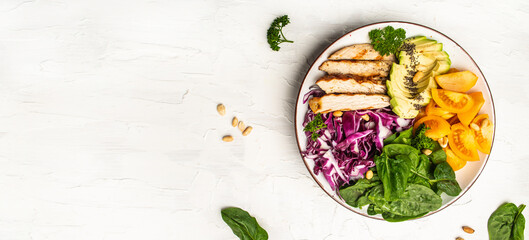 Pieces of chicken fillet with fresh tomatoes, cabbage, spinach and avocado. Proper nutrition. Detox and healthy concept. Keto paleo lunch. Long banner format, top view