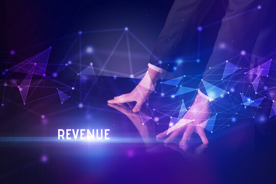 Businessman touching huge screen with REVENUE inscription, modern technology business concept