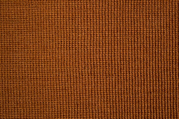 Embossed brown woolen background. Warm clothes.